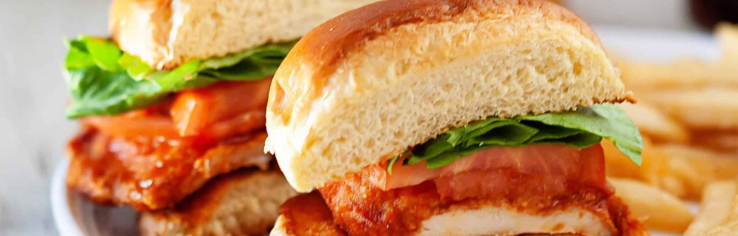 Cross Section of Chicken Sandwich with Fries on a Plate